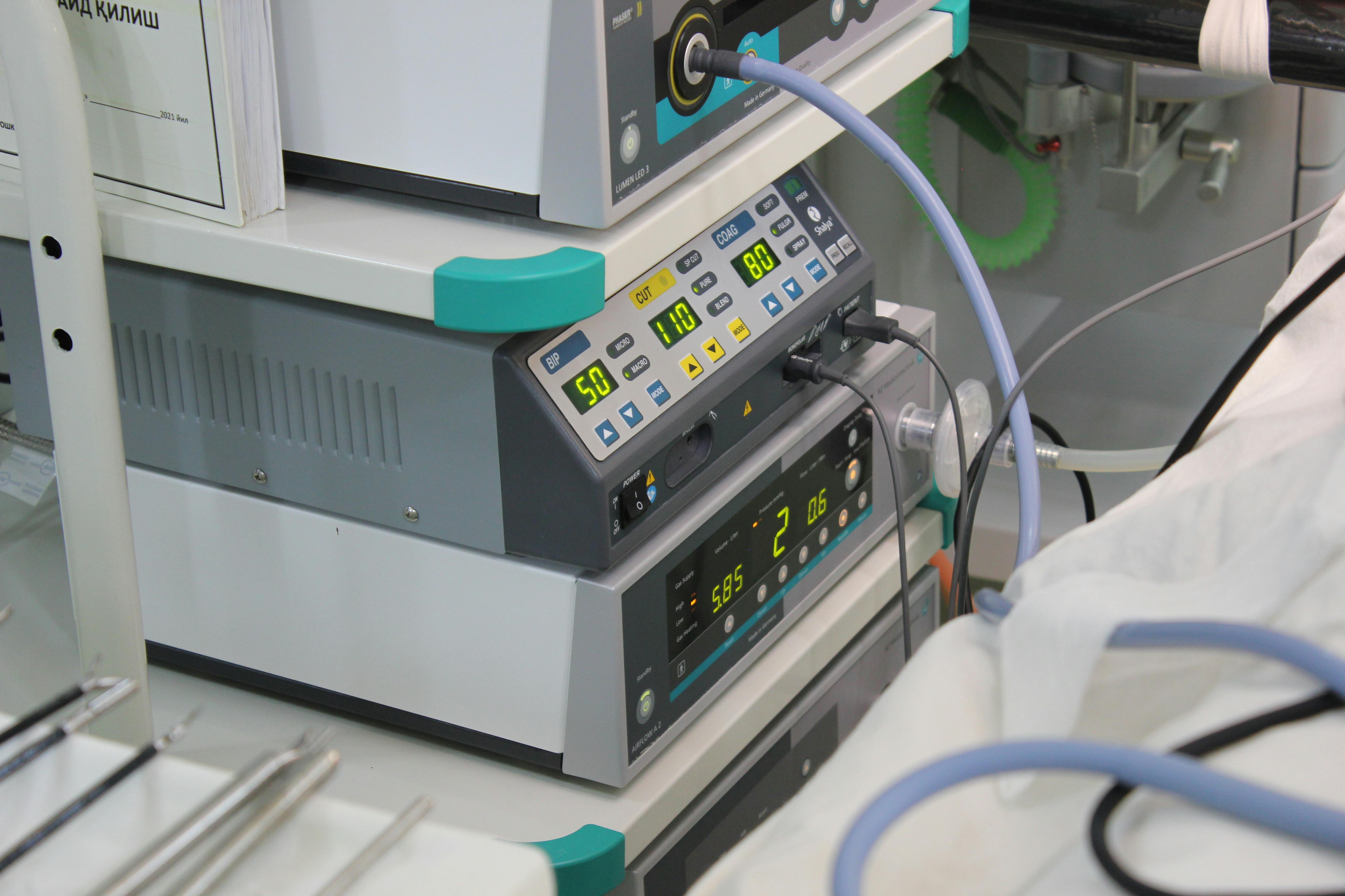 Close-up view of medical device with digital displays and cables in a hospital setting